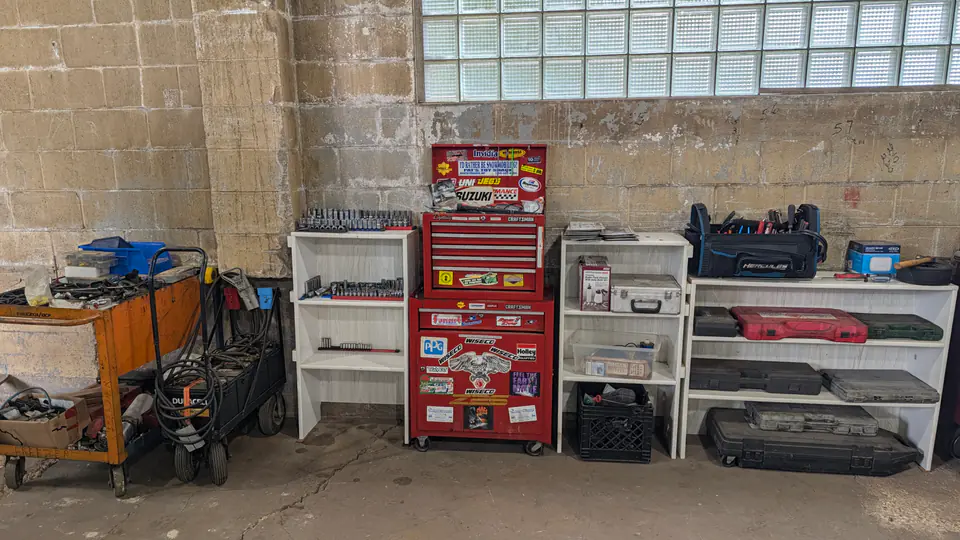 Tool chests, storage cabinets, and a workbench inside the Dairyland shop